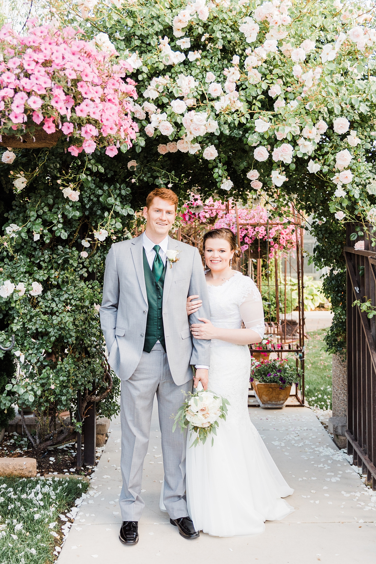 Utah summer wedding photography at Le Jardin and the Jordan River Temple, bride and groom with flower arch