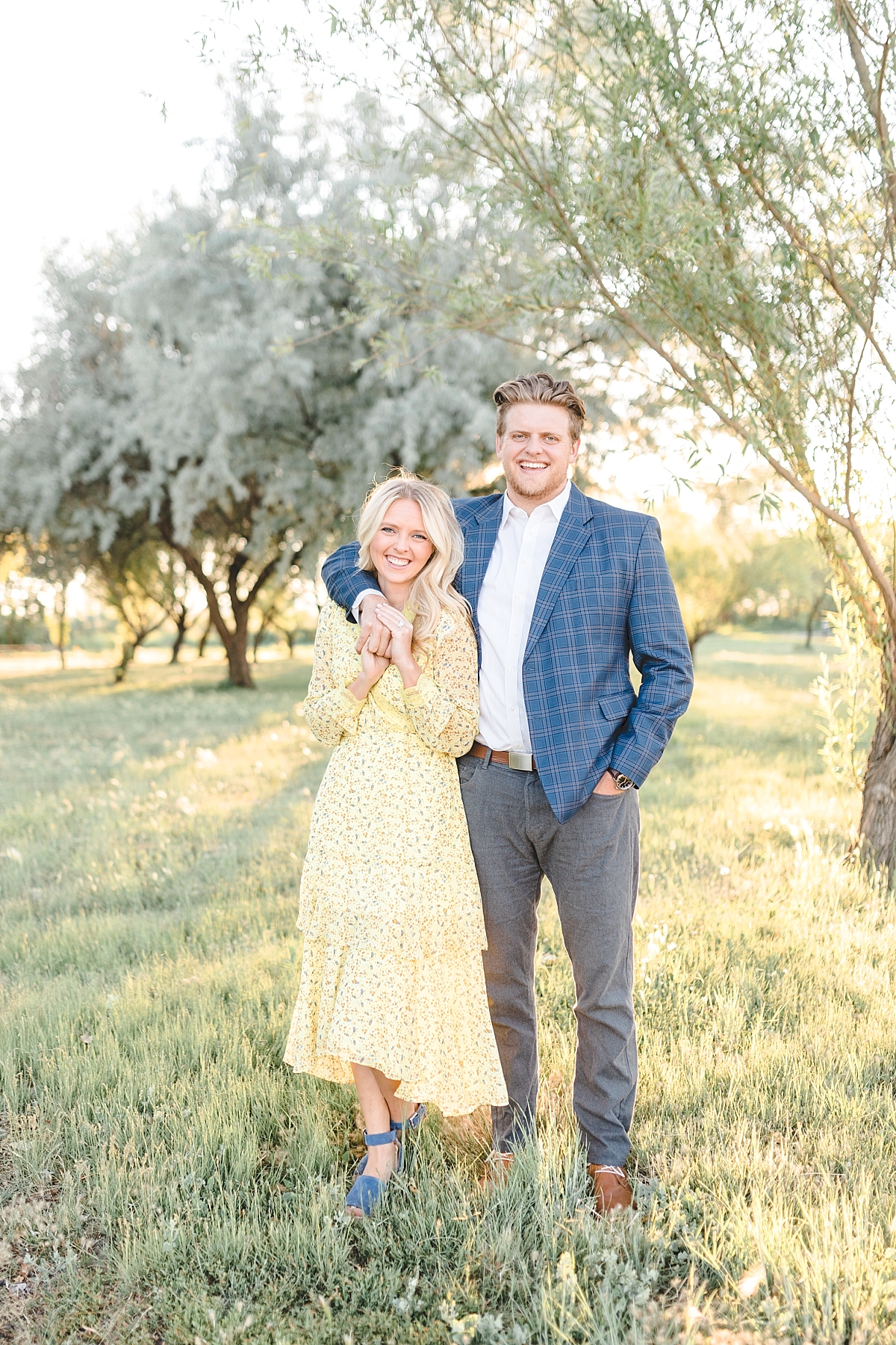 Bountiful pond couples session, twirling yellow dress and blue high heels, Pinstripe jacket and suit pants, Photography by Tasha Rose, Utah couples photographer